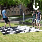 Giant Draughts at a university event being enjoyed by 3 students