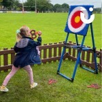 Axe Throwing Set up Hire at an outdoor family fun day being used by a little girl