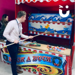 Man having a go at our Christmas themed Hook a Duck Side Stall