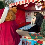 Penguin Skittles Alley Stall With Santa Bear Having A Go at winning a prize