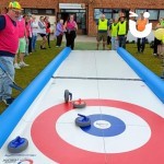 Curling Lane Hire at a fun team building event with people enjoying the competition