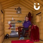 elaborate wooden throne hire set up in our inflatable grotto with a happy lady sat in it