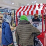Candy Floss Cart at a shopping centre with 2 teenagers being served fresh portions