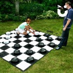 Man and Women playing on the Giant Draughts Game