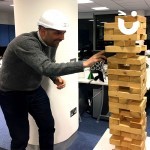 A man wearing a safety helmet whilst on the Giant Jenga Hire