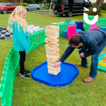 Father and daughter playing Giant Jenga in our Giant Games Area