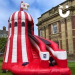 Inflatable Helter Skelter Slide at a Corporate fun day with a man zooming down it
