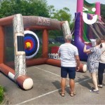 Inflatable Axe Throwing at a family fun day with an adult family enjoying playing