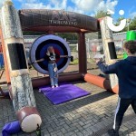 Inflatable Axe Throwing at an outdoor family fun day with a brother and sister playing