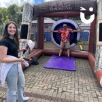 Inflatable Axe Throwing at a family fun day with a daughter and dad having fun
