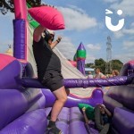 Pole Joust Inflatable at a family fun day being enjoyed by a man and boy