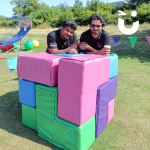 Two Fun Experts leaning on our Puzzle Cube for Team Building 