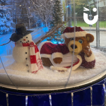 Santa Bear laying down inside our Giant Snow Globe