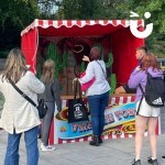 Cactus Stoss Stall Hire at a corporate family fun day with a woman throwing a hoop and people watching on