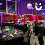 Multiple side stalls at an indoor evening ceremony