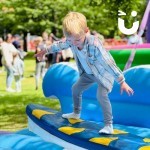 Surf Simulator Hire at a family fun day with a young boy enjoying it