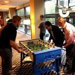 Group of men playing on the Our Table Football Hire